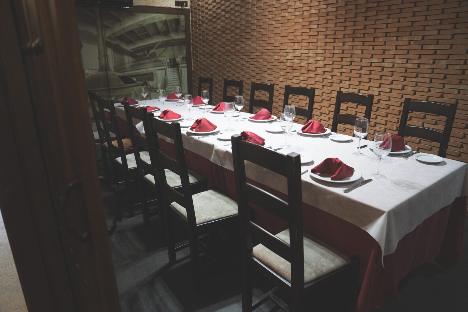 Salón privado de restaurante con mesa larga preparada para evento